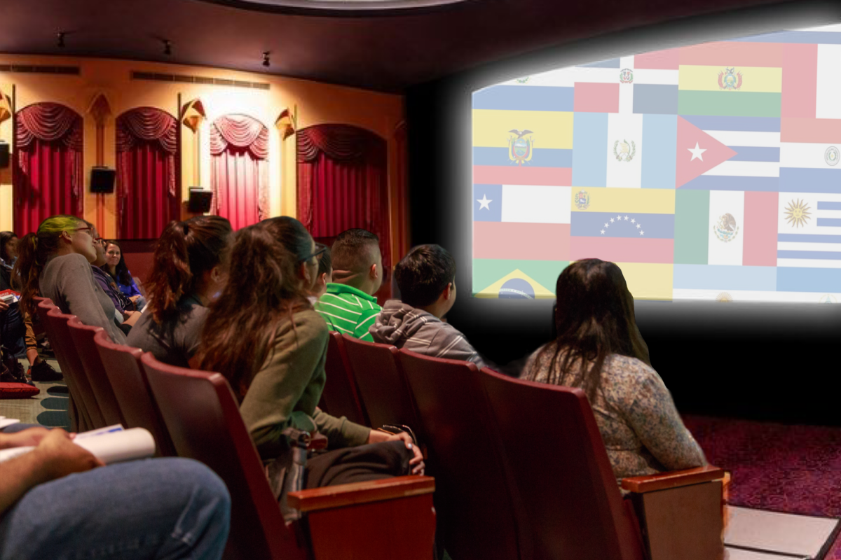 Latinos sitting in a theater looking at a screen with Latin-American flags.