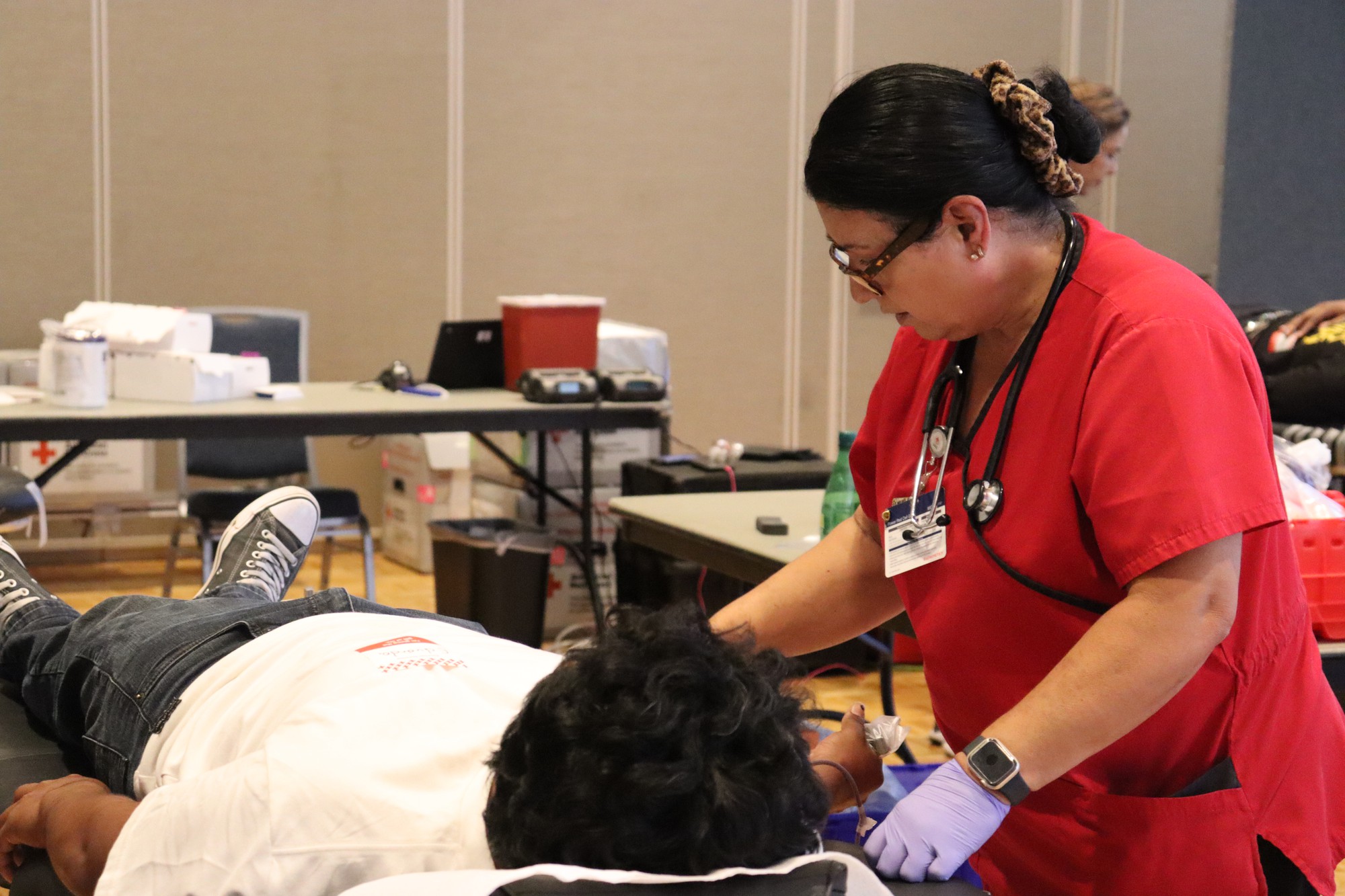 Nurse helping a patient while donating his blood. 
