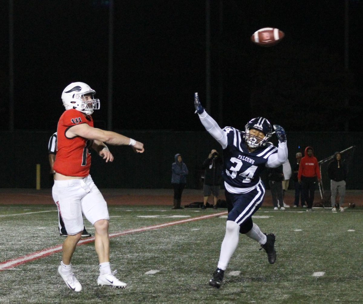 LBCC quarterback throwing the ball as #34 Macc Manu tries to block the ball.