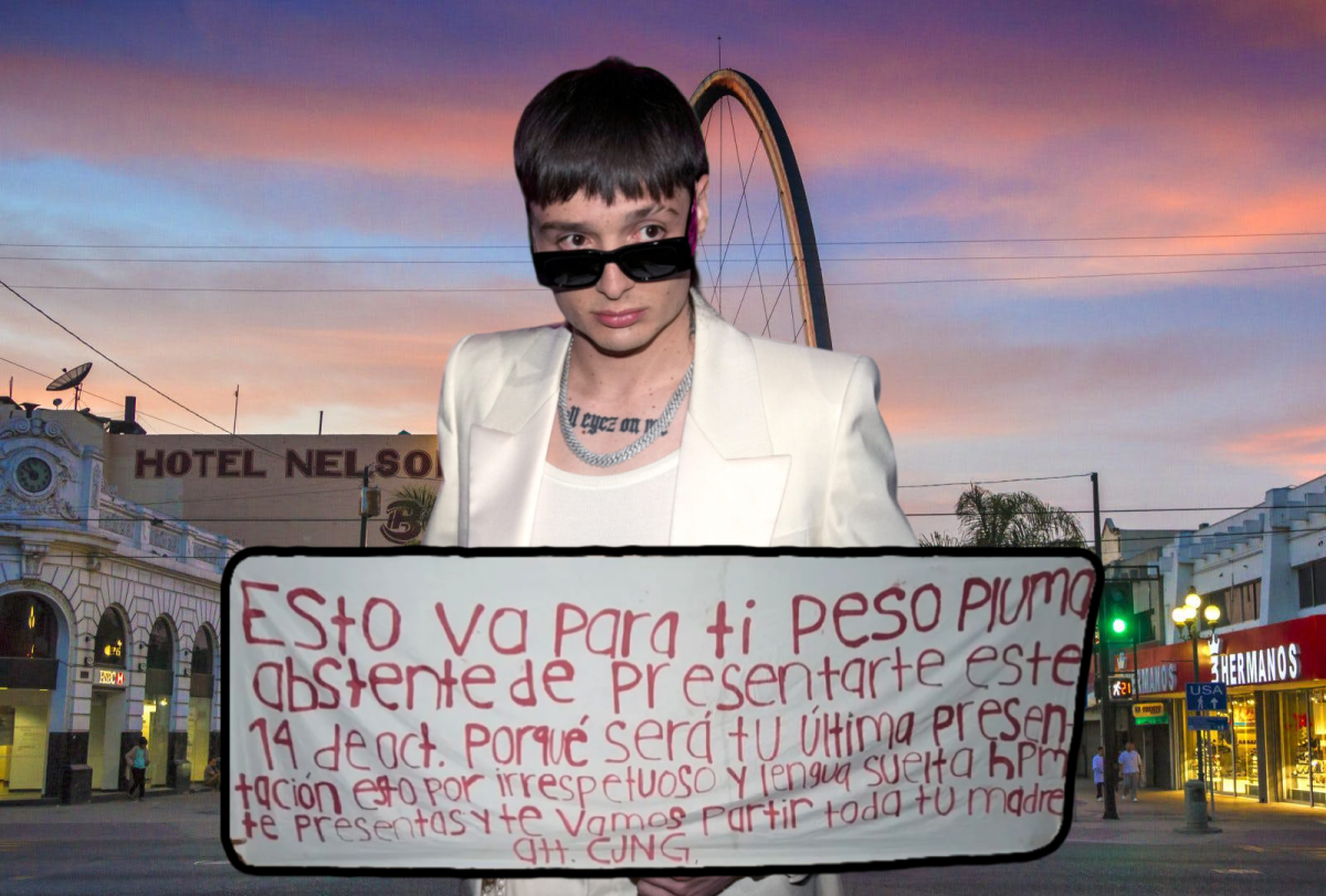 Peso Pluma standing in front of the Arco de Tijuana with a death threat poster in front of him from the CJNG cartel. 