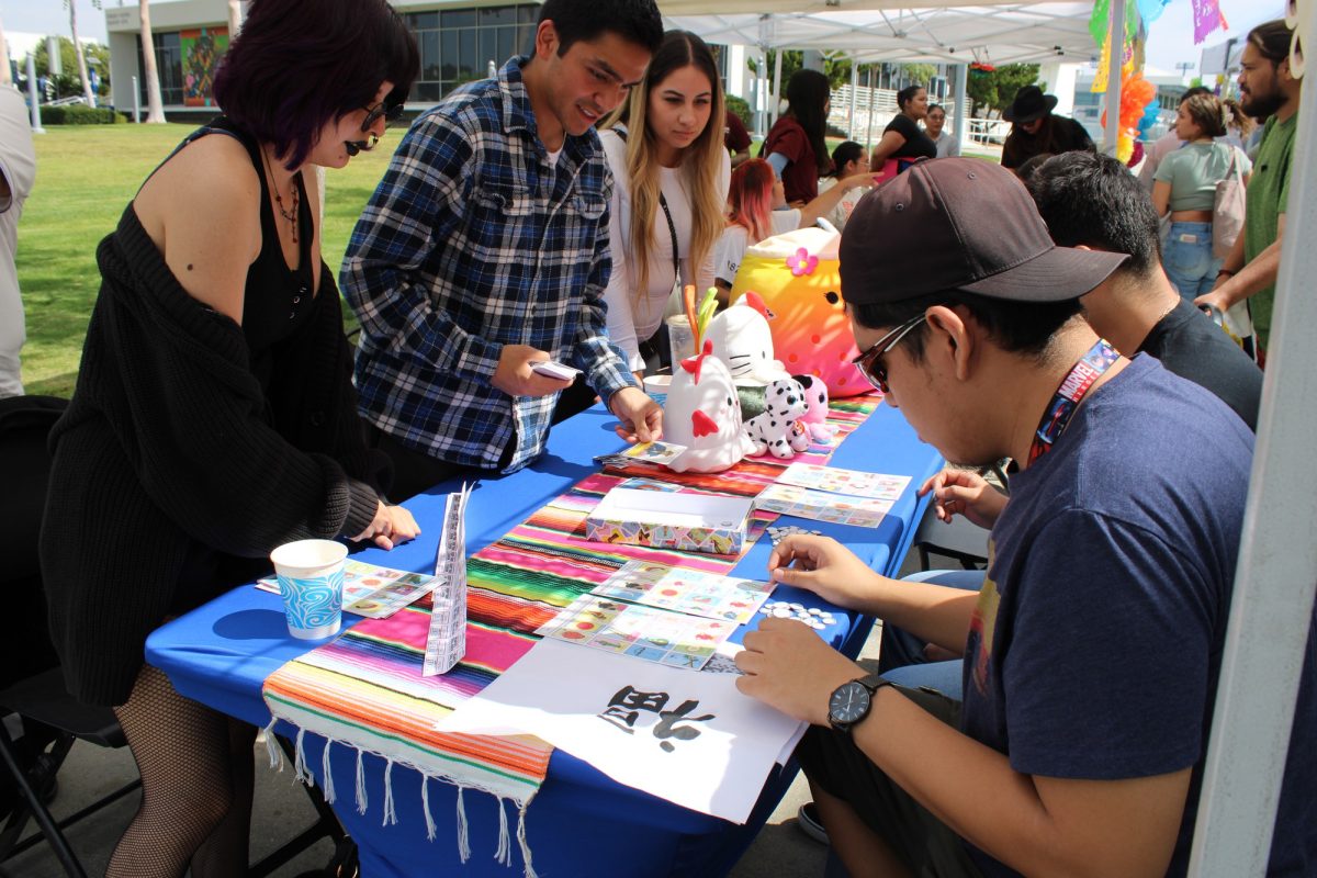 Students attending La Feria Latina playing loteria. 