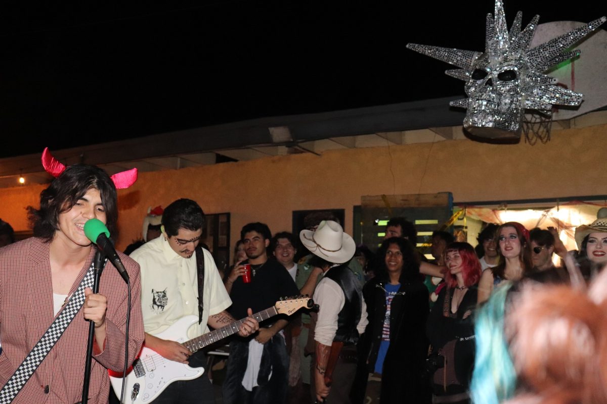 Costumed partygoers gathered beneath a disco skull and danced as Jamie Blue performed.