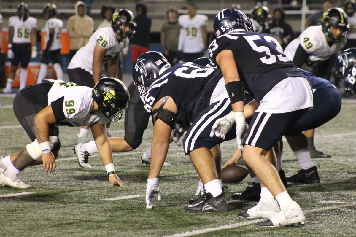 Cerritos College lines up at the line of scrimmage to snap the ball. 
