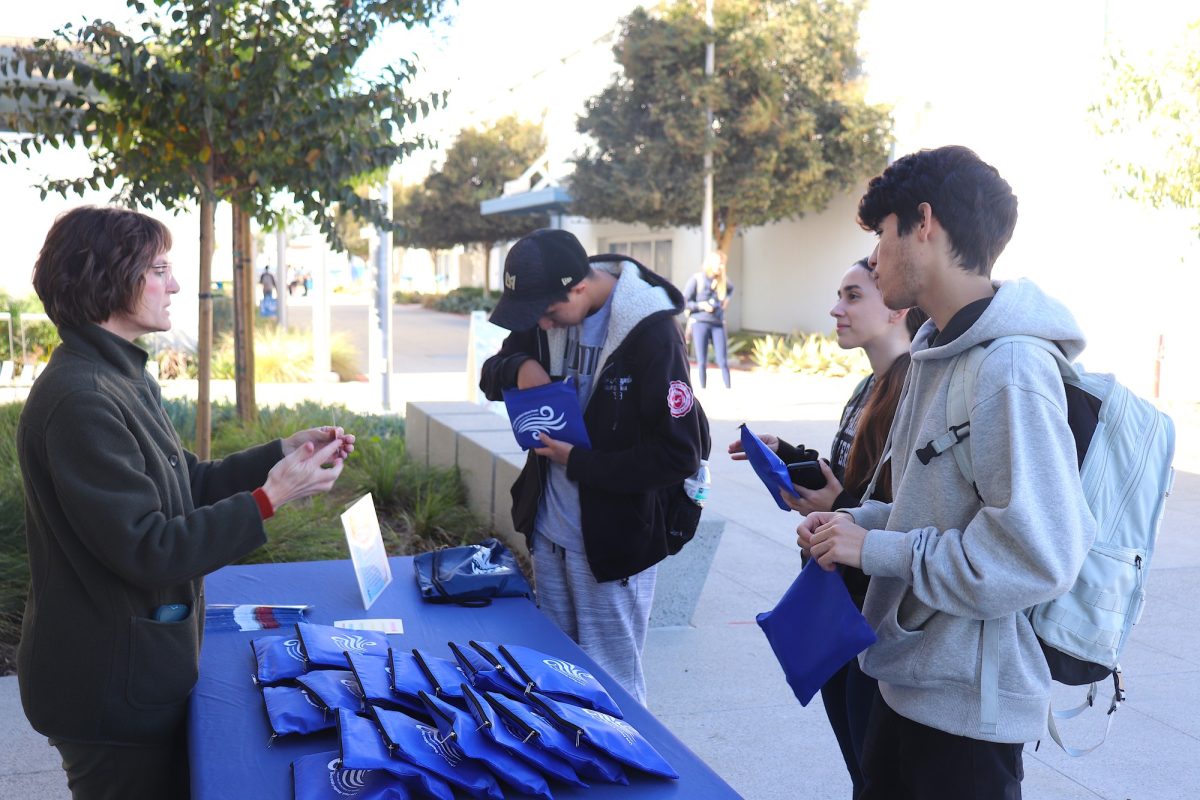 Cerritos College Social Worker Angela Williams engages with students and informs them on the coping kit.