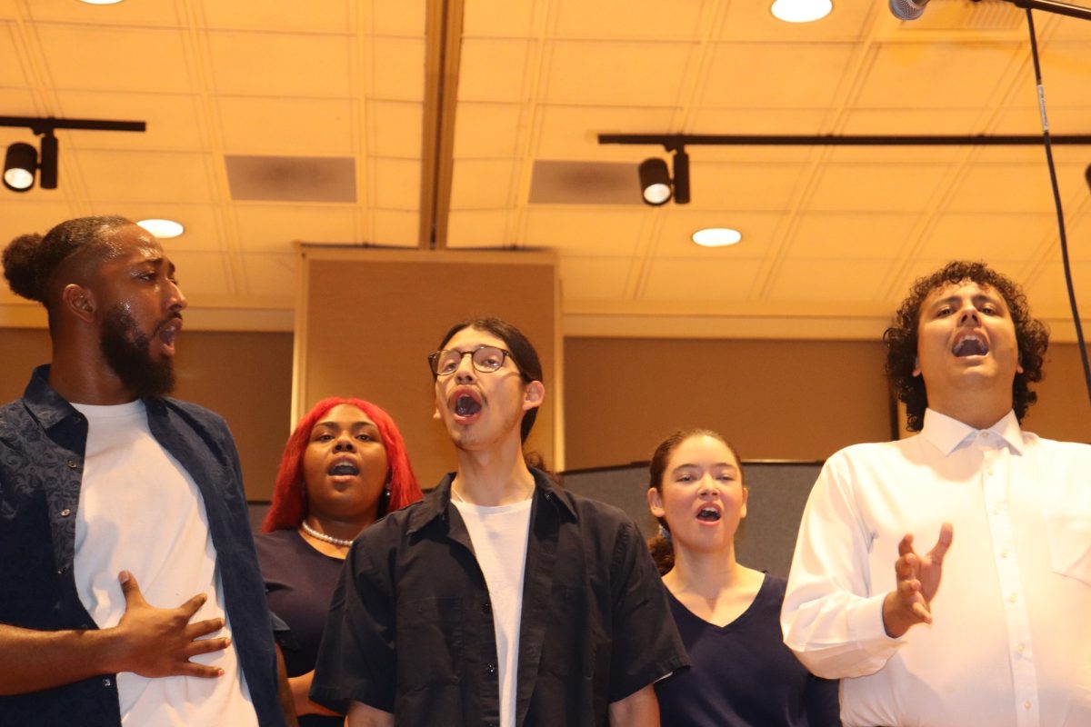Choir members sing in unison with one another. 