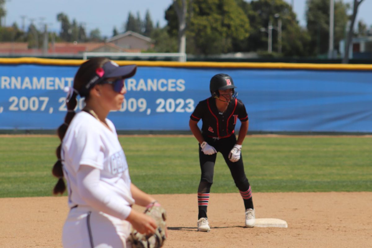 Natalie Basurto watching the pitch while Xiomei Geluz from LBCC attempts to steal base. 