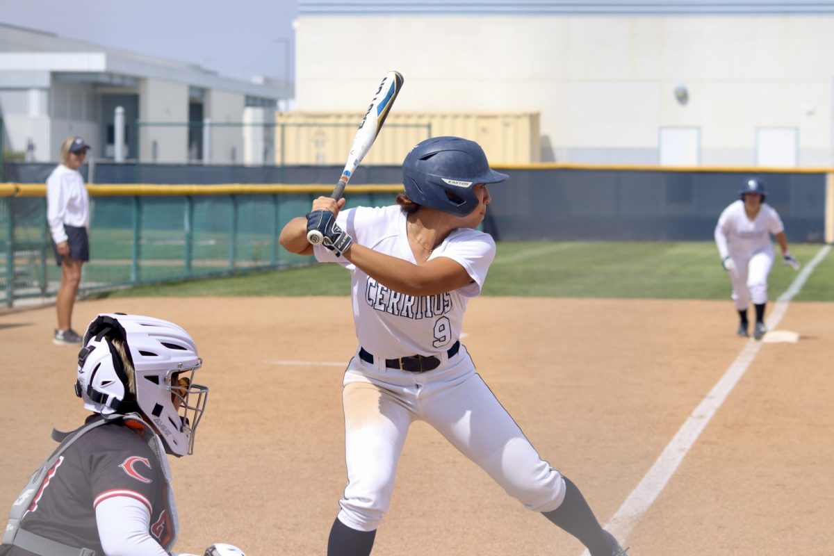 Shortstop, Marley Manalo, trying to record a hit to drive in her teammate to score. 
