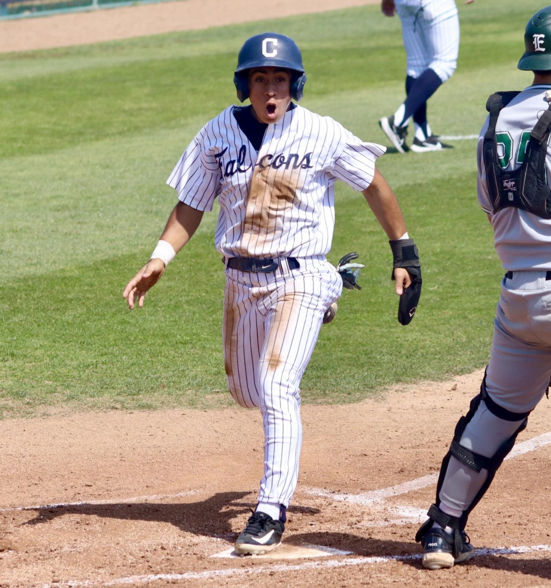 Outfielder, Diego Orozco, yelling as he crosses home plate to score for the Falcons. Photo credit: Joel Carpio