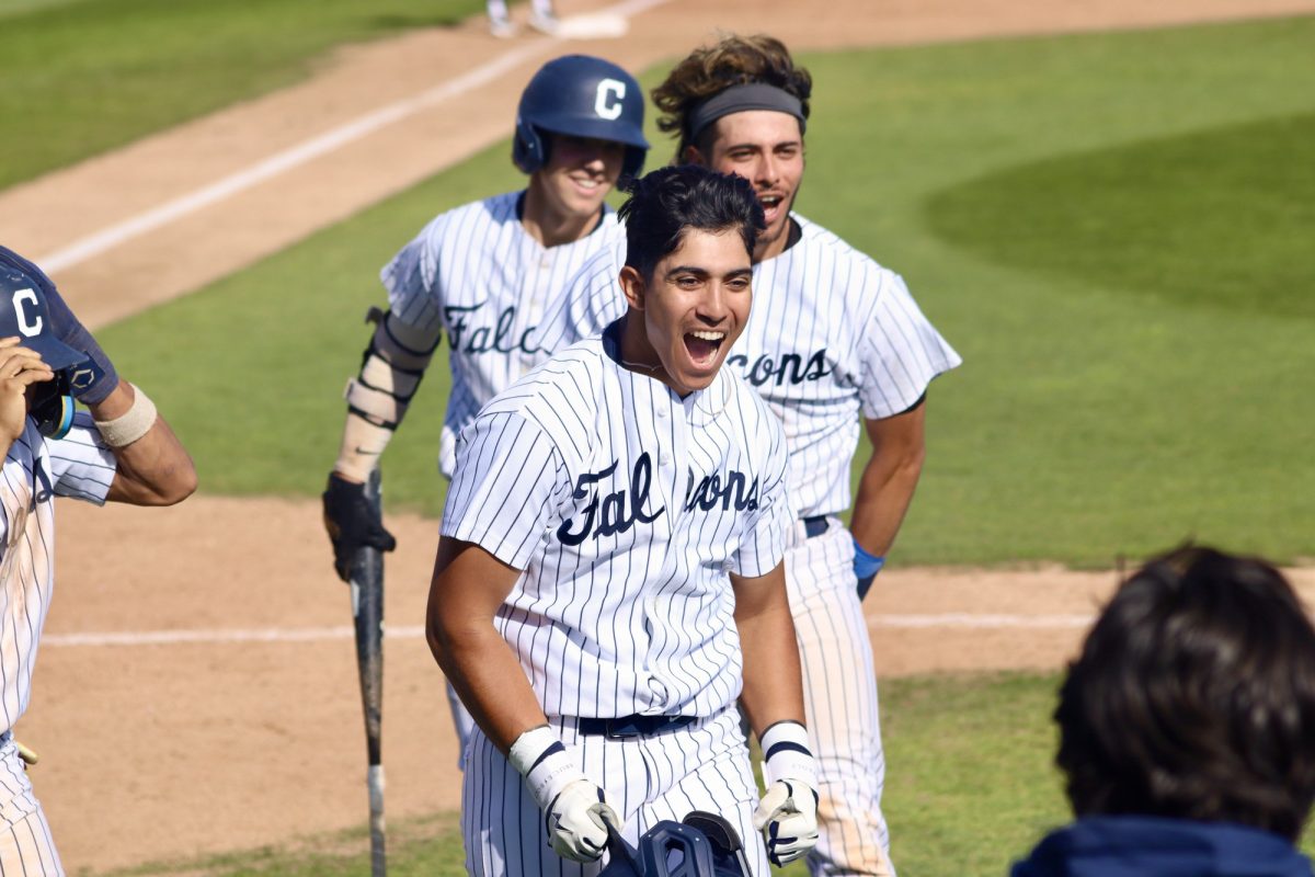 First baseman, Mike Santos, smiling and yelling after rounding the bases from his grand slam. 