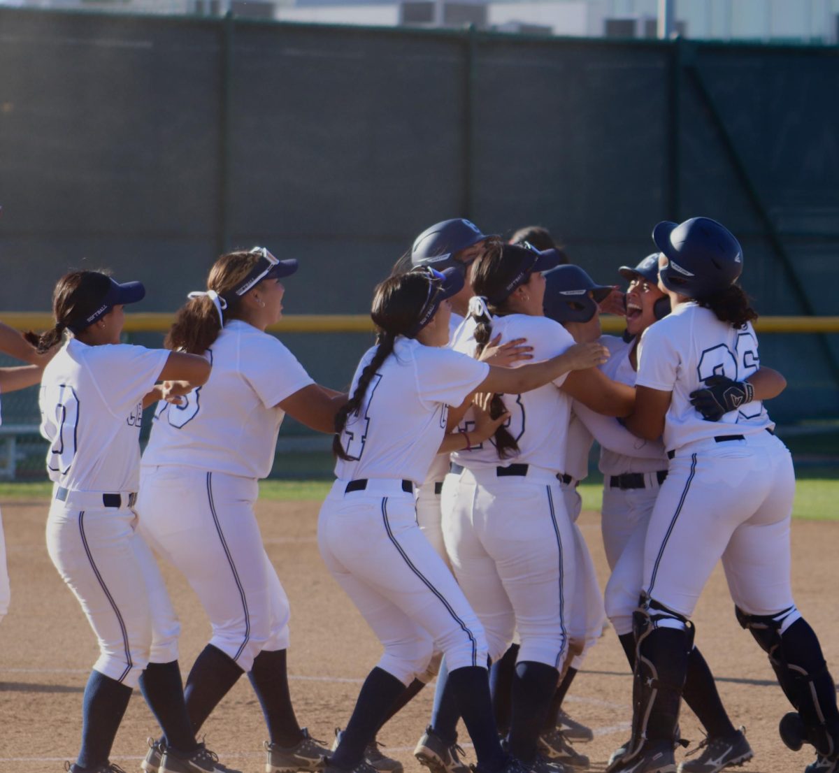 Falcons players running up to Marley Manalo after she hit a walk-off single to give them the win against Mt. Sac