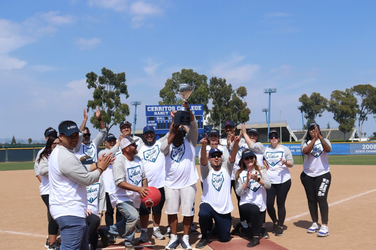 Employees gathered together celebrating and raising the trophy after being named winners. 