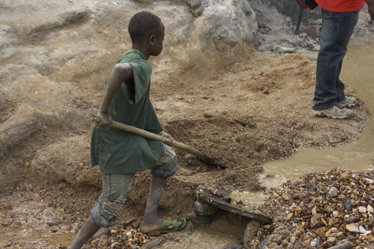 A child miner, Patrice, 15, working at a gold mine in Congo.