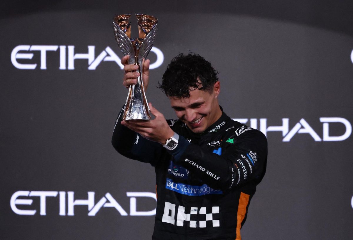 Formula One F1 - Abu Dhabi Grand Prix - Yas Marina Circuit, Abu Dhabi, United Arab Emirates - December 7, 2025 McLaren's Lando Norris celebrates on the podium with the trophy after becoming the 2025 Formula One World Champion REUTERS/Amr Alfiky