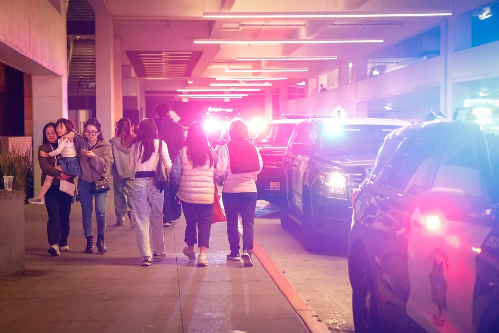 Families leave the Westfield Valley Fair mall in Santa Clara, CA while police secure the area on Nov. 28, 2025. Photo credit: Shae Hammond/Bay Area News Group