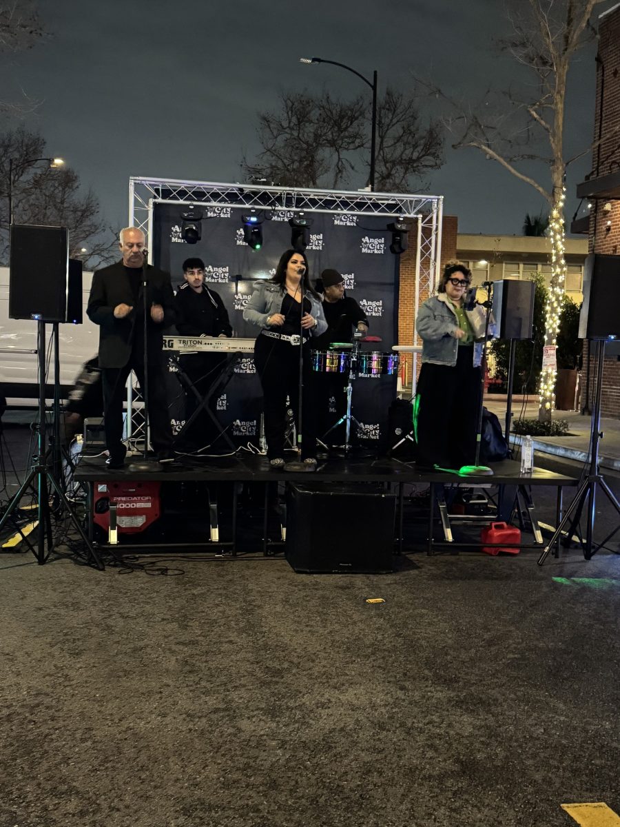The Azugar Los Angeles Band starts playing live on stage, as cumbia starts to fill the night market, communities gather around to dance on Jan. 22, 2026. 
