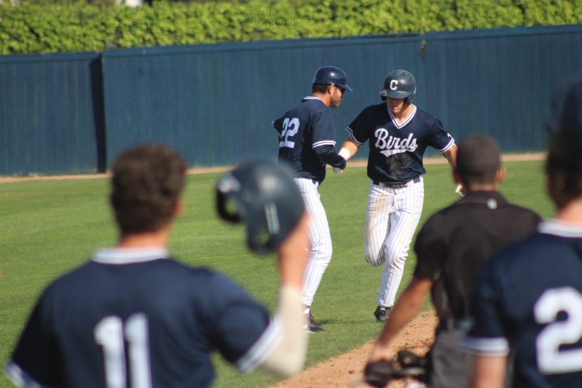 First baseman CJ Berthon rounds the bases and shakes his third base coach's hand after hitting his fourth inning three-run home run against Southwestern College at Kincaid Field on Saturday, Feb. 14, 2026. Berthon went 3-for-4, was a double shy of the cycle and extended his hitting streak to six games.